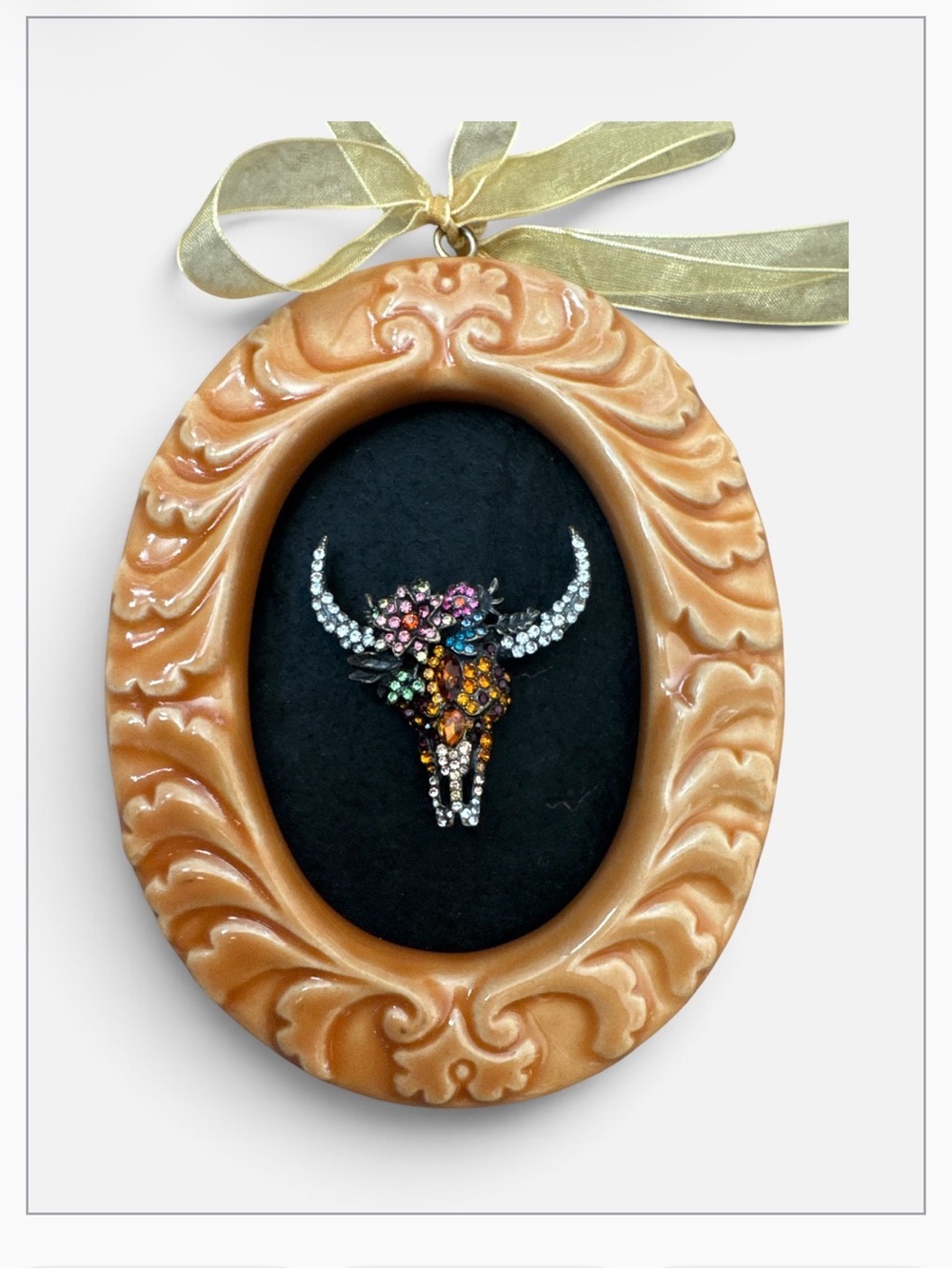 Ornate Peach Oval Wall Frame with Multicolor Crystal Bull Skull Brooch